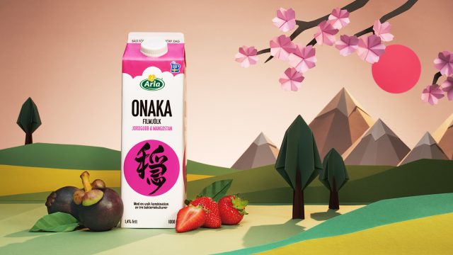 a carton of milk next to fruit and paper cut trees