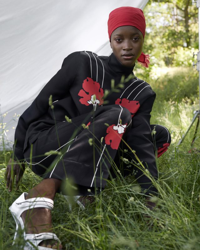 a woman sitting in grass
