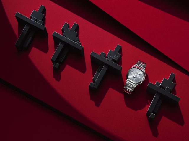 a watch and black plastic crosses