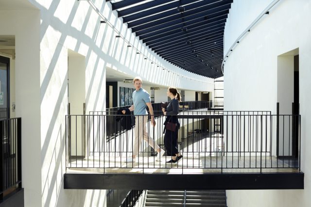 a man and woman walking on a balcony