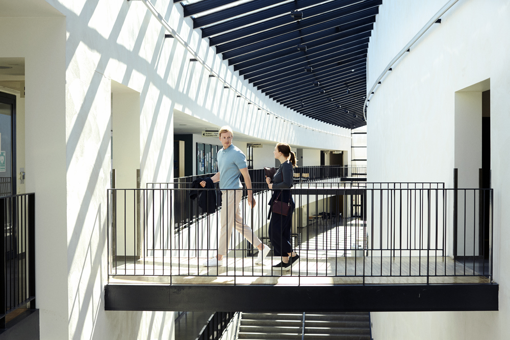 a man and woman walking on a balcony