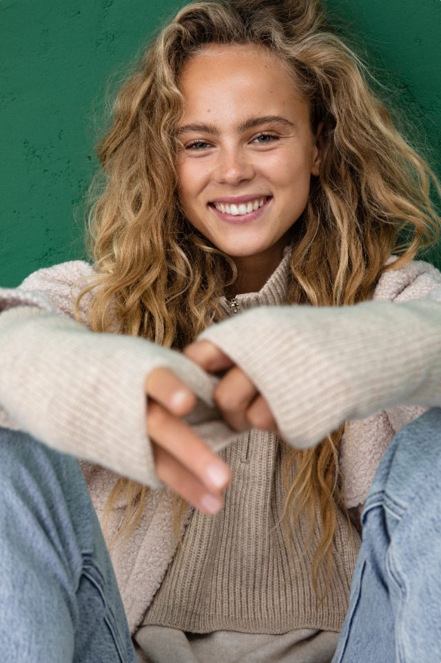 a woman smiling with long hair
