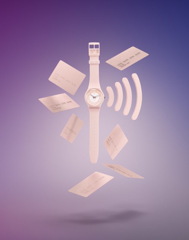 a watch with credit cards flying in the air
