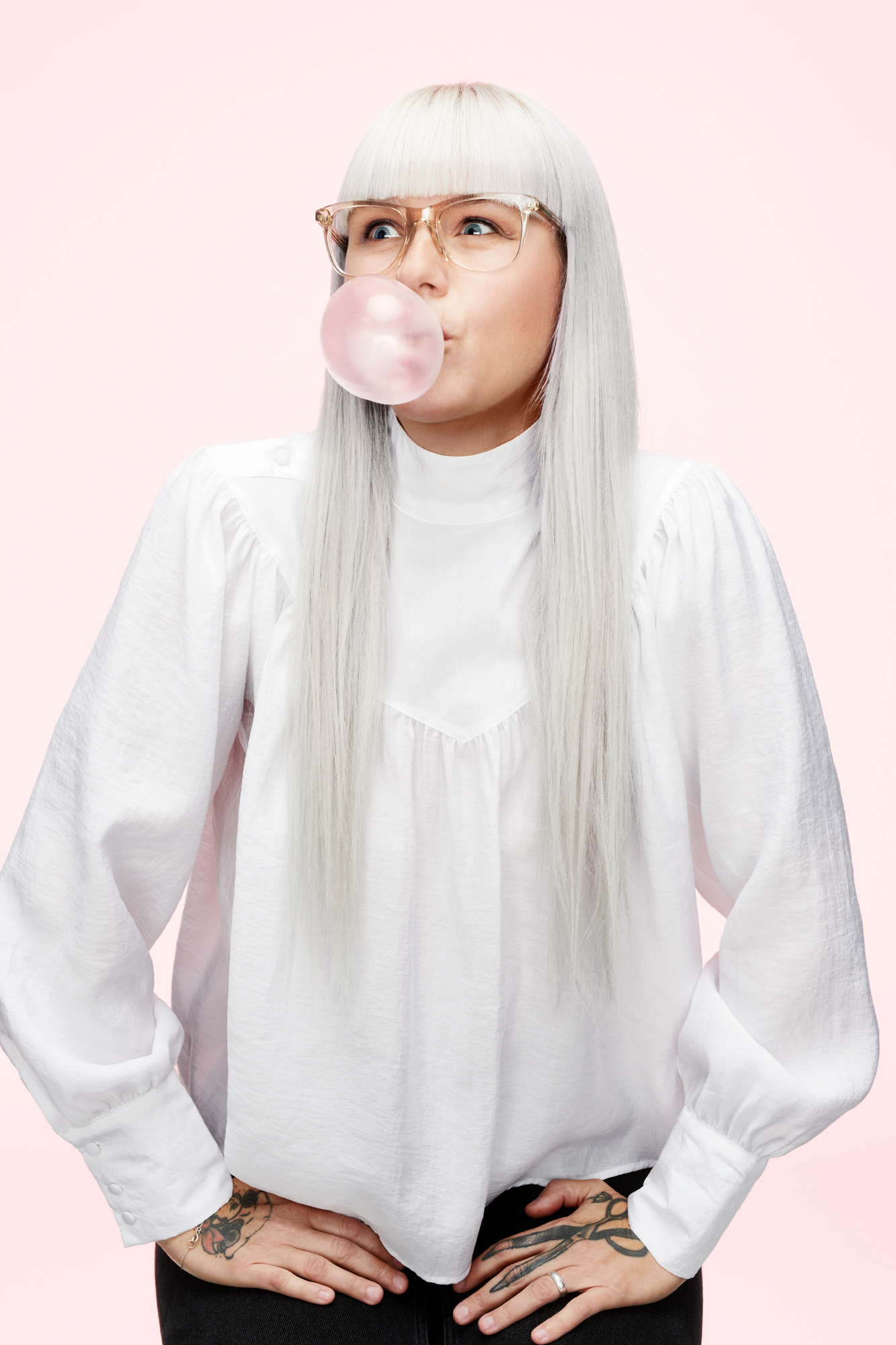 a woman blowing a bubble