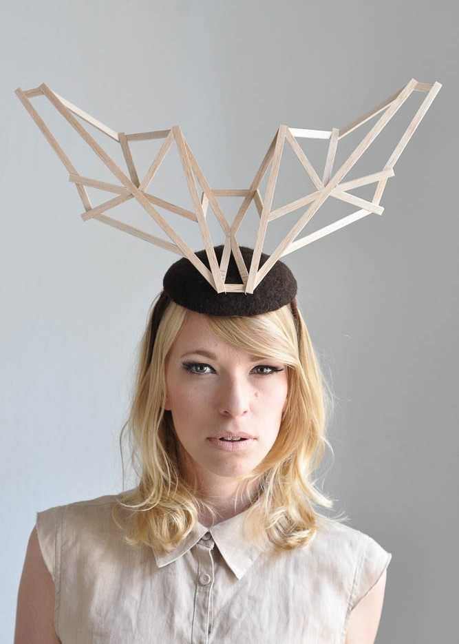 a woman wearing a hat with a wooden object on her head