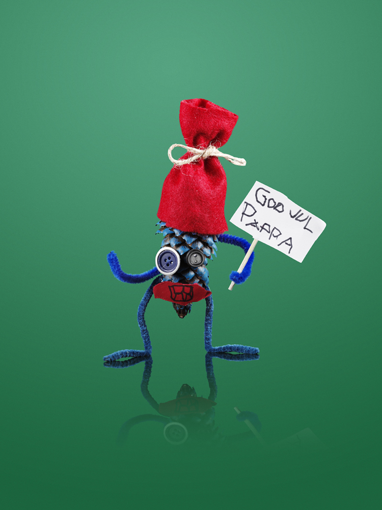 a blue and red pinecone holding a sign