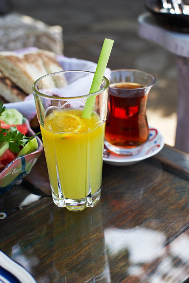a glass of juice and a bowl of tea