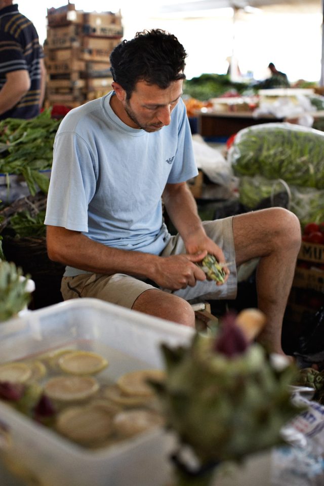 a man sitting at a market