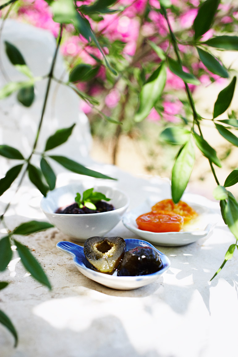 a group of bowls of fruit and jam
