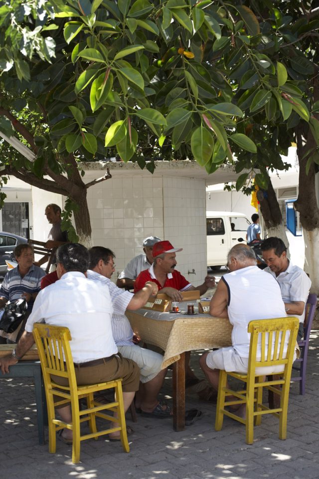 a group of men sitting around a table