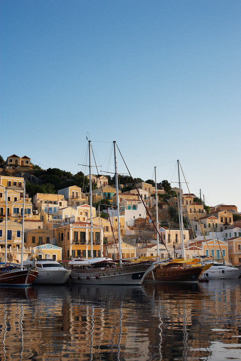 boats in a harbor with buildings in the background
