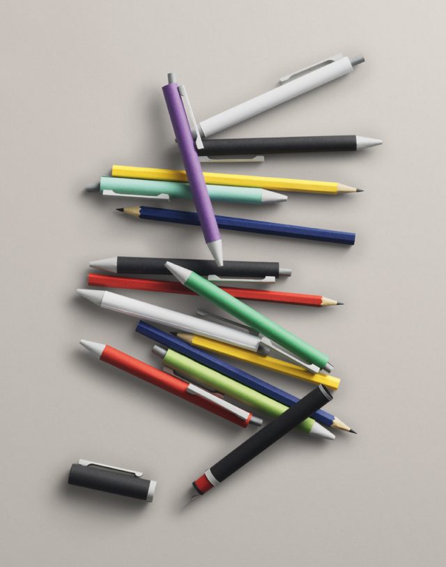 a group of pens on a white surface