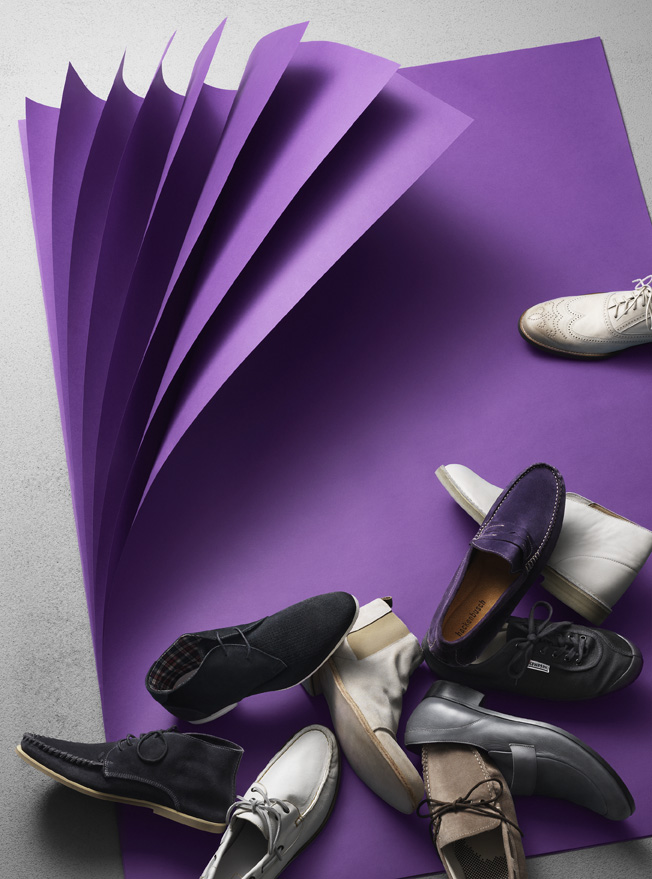 a pile of shoes on a purple surface