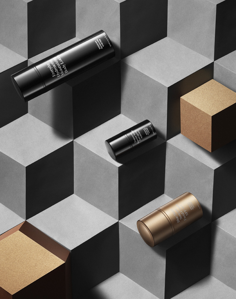 a group of black and gold containers on a grey and white cubed surface