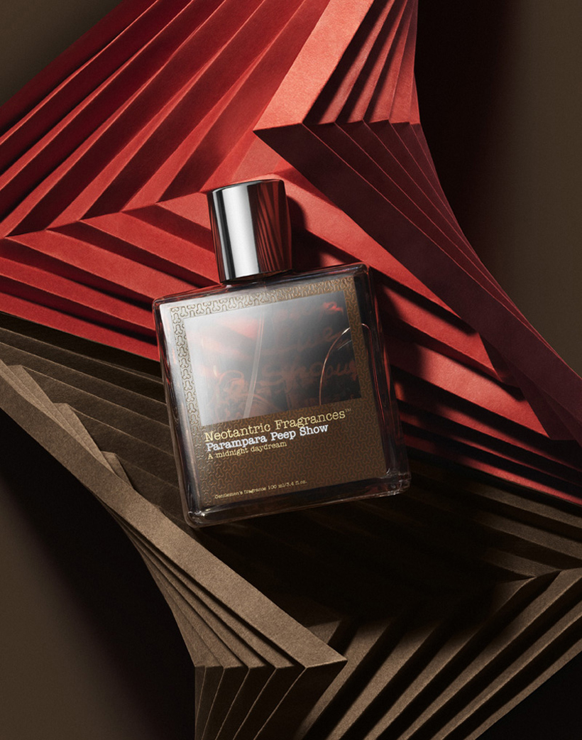 a bottle of perfume on a pile of paper