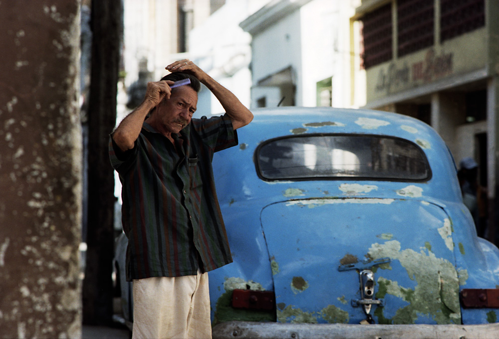 a man standing next to a car