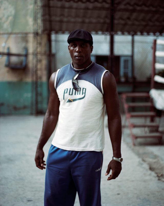a man in a tank top and cap