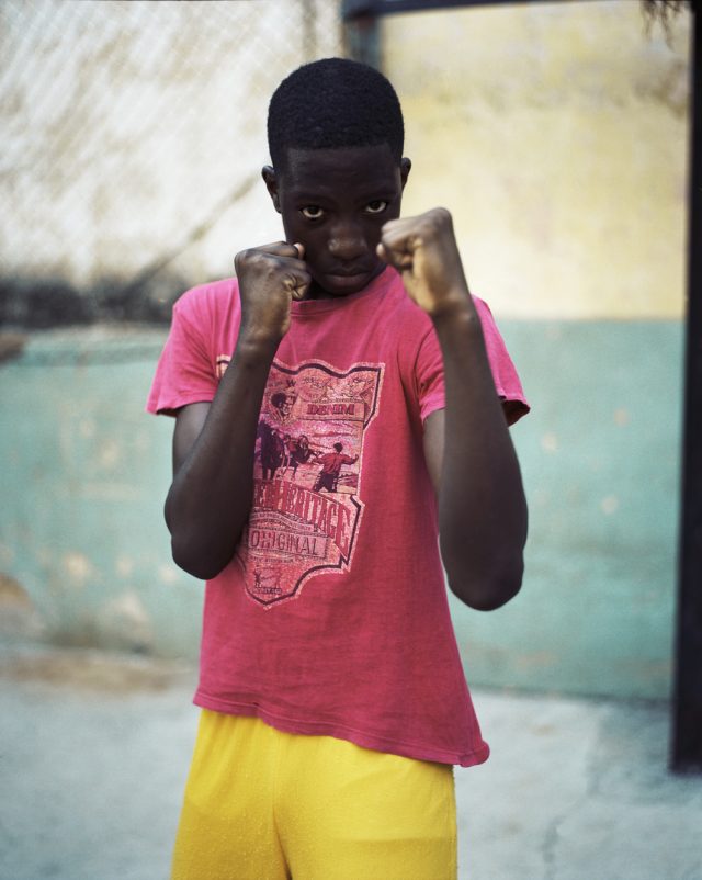a boy with his fists in front of him