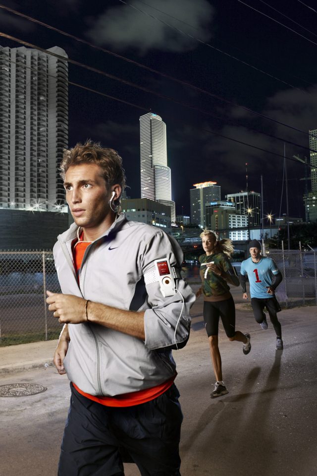 a group of people running on a city street