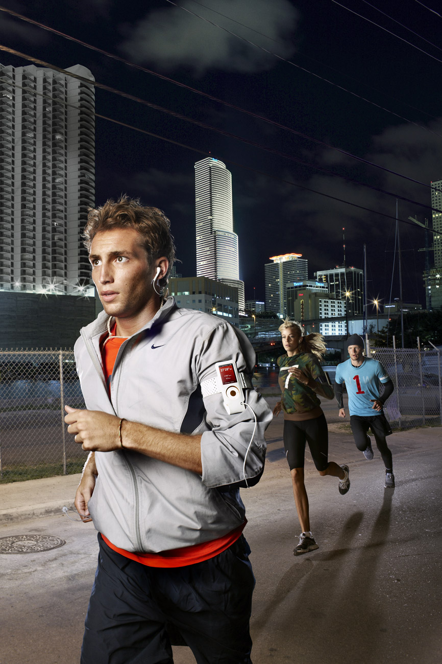 a group of people running on a city street