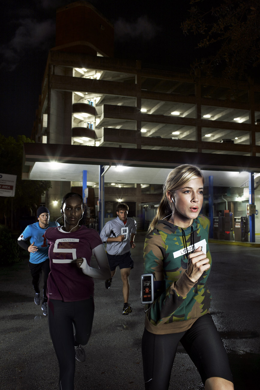 a group of people running at night