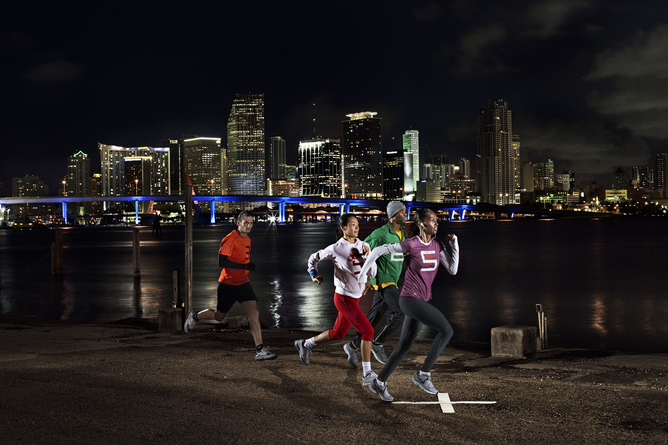 a group of people running on a beach