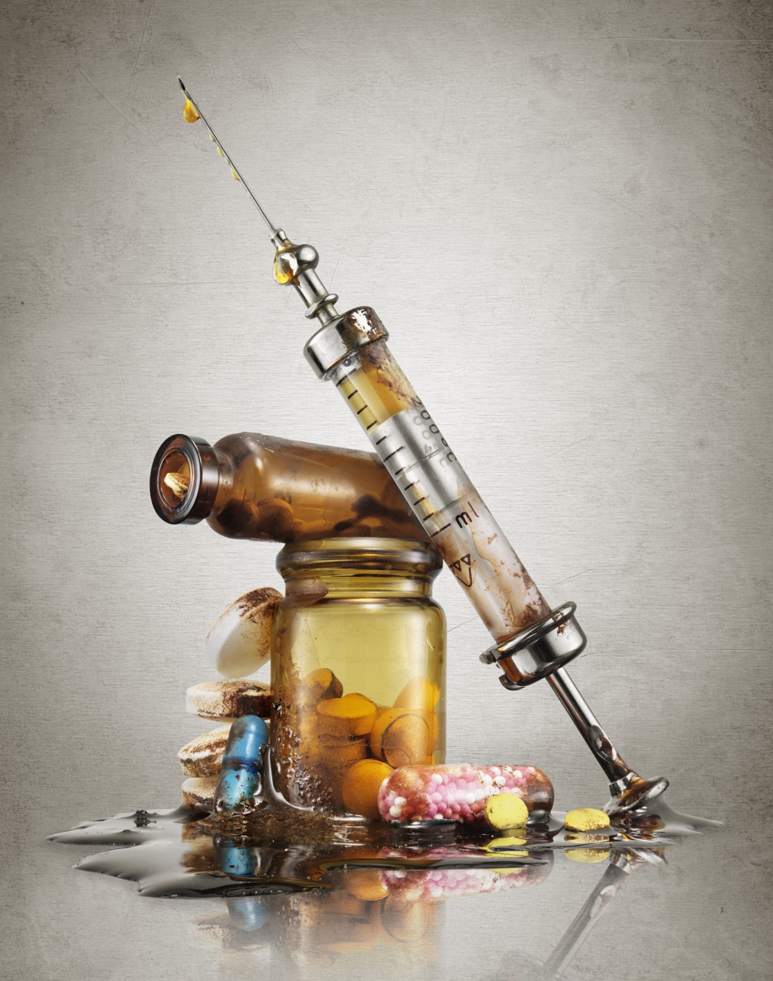 a syringe and a bottle of pills