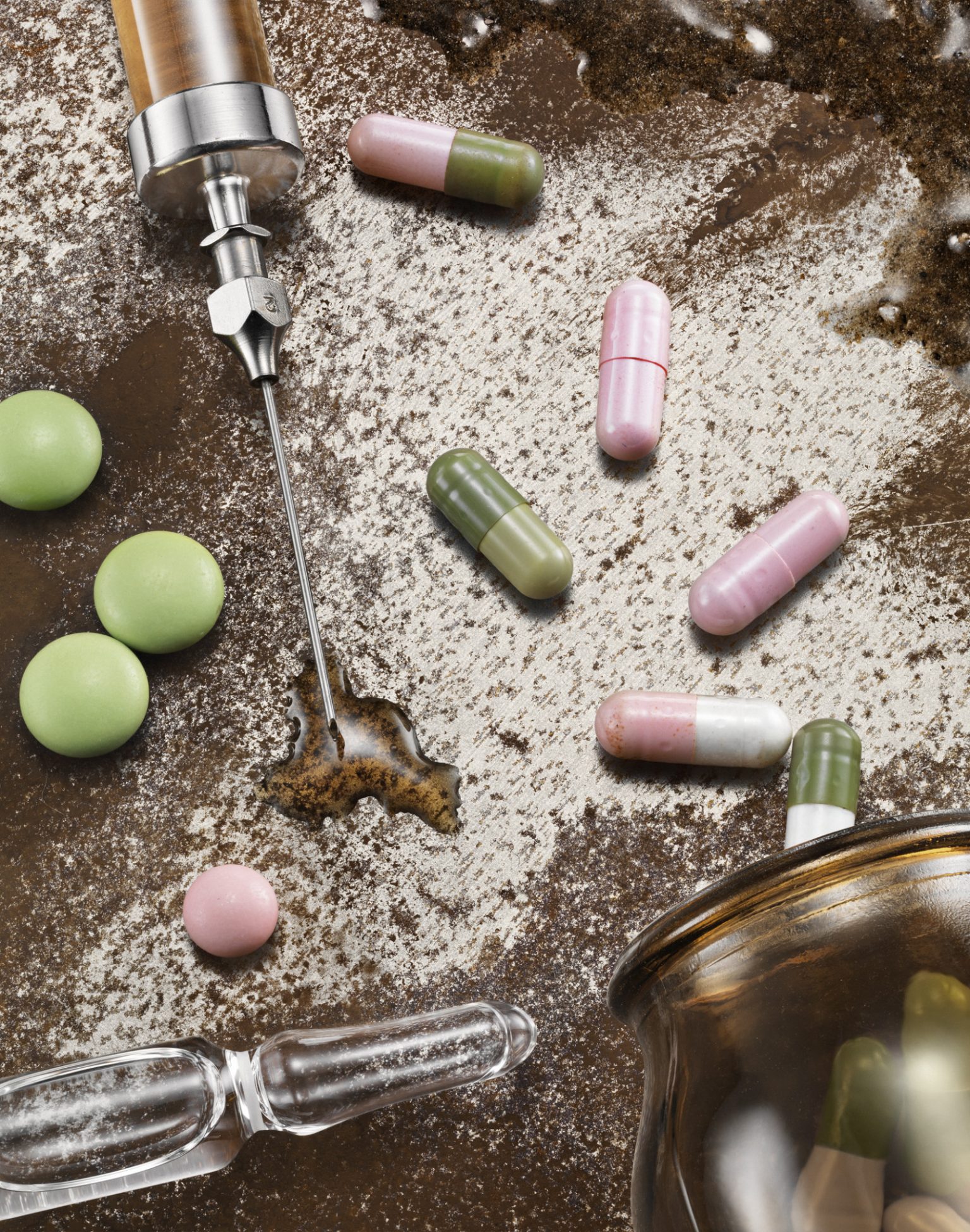 a syringe dropping pills into a jar