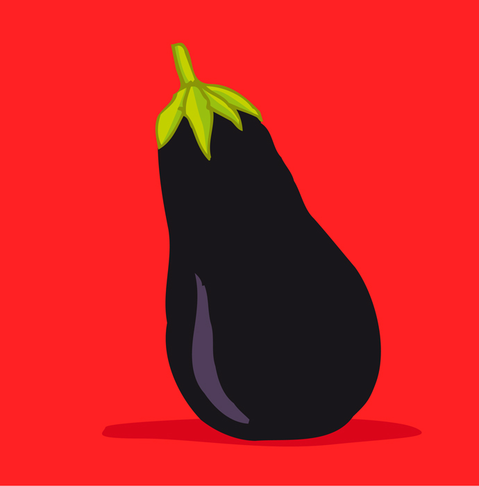 a black eggplant with green leaves