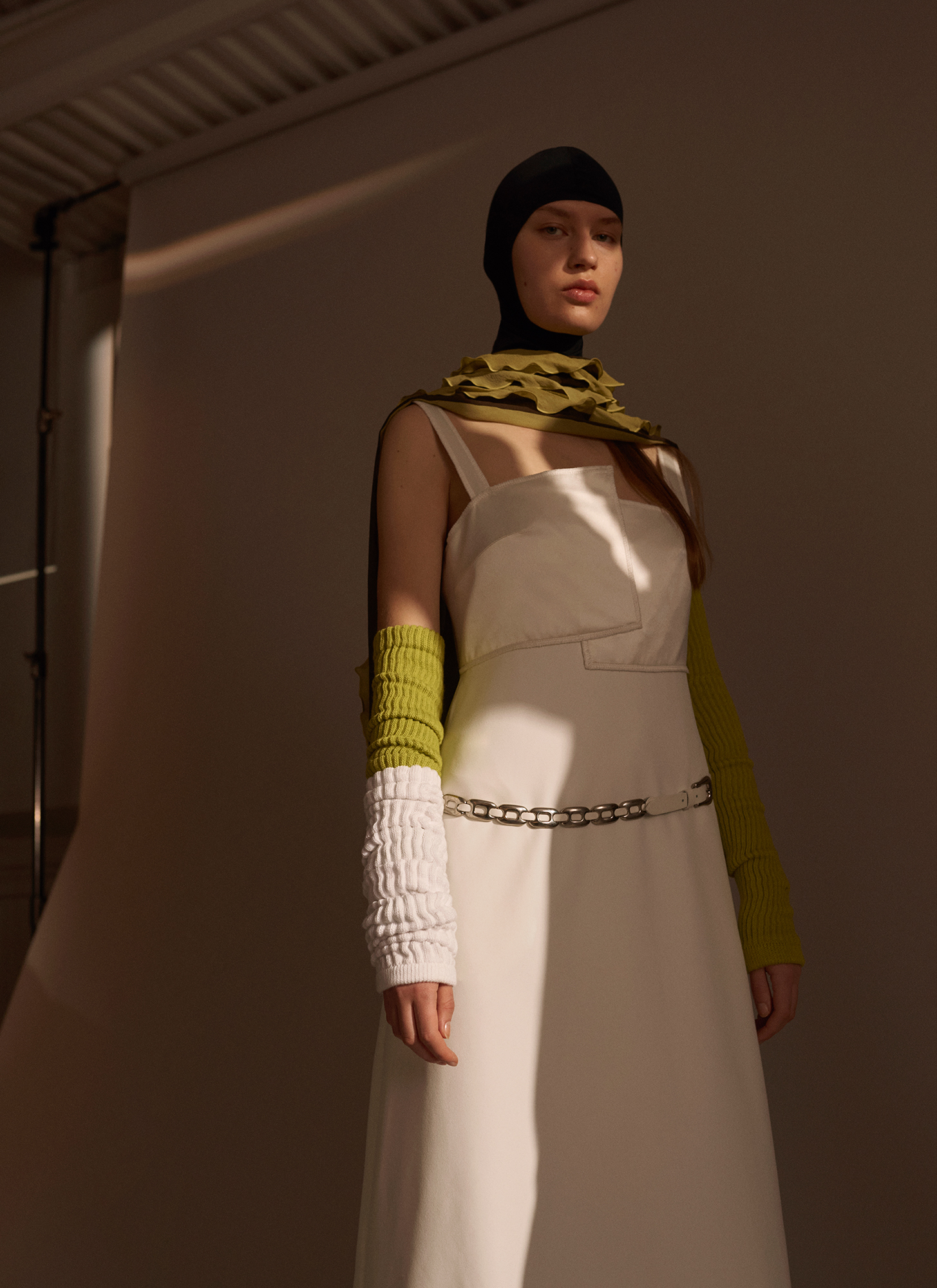 a woman in a white dress and black hat