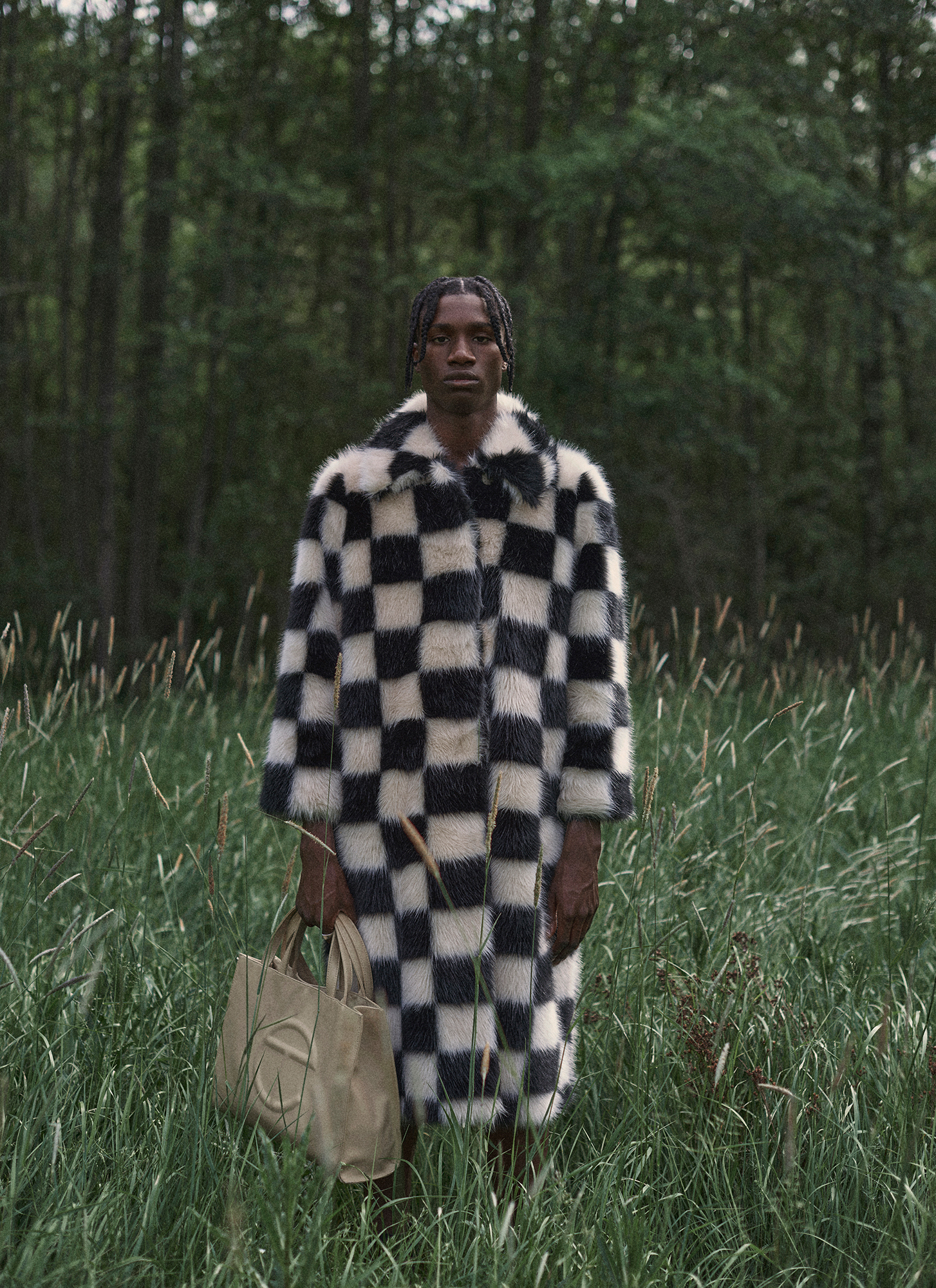 a man in a checkered coat in a grassy area