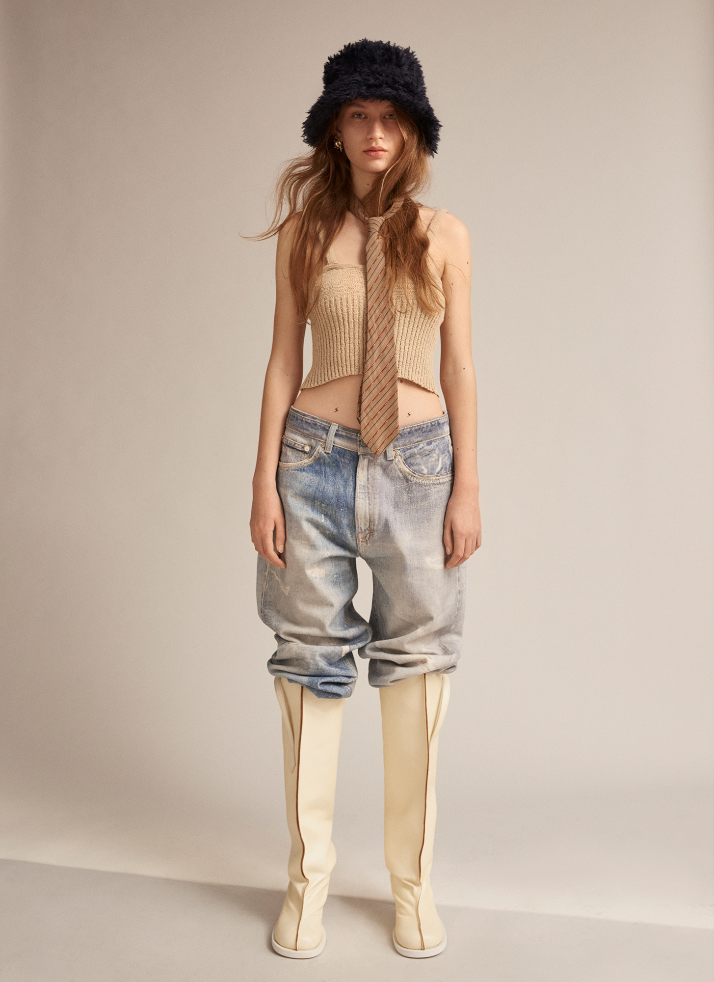 a woman wearing a hat and jeans