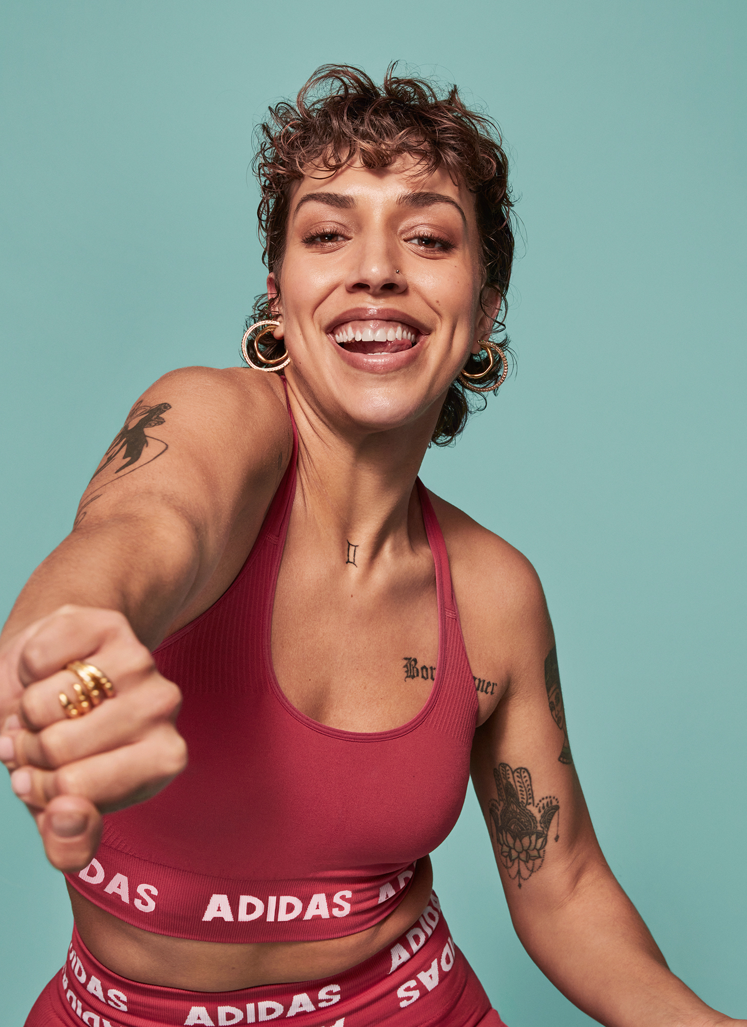 a woman smiling with her hand in the air