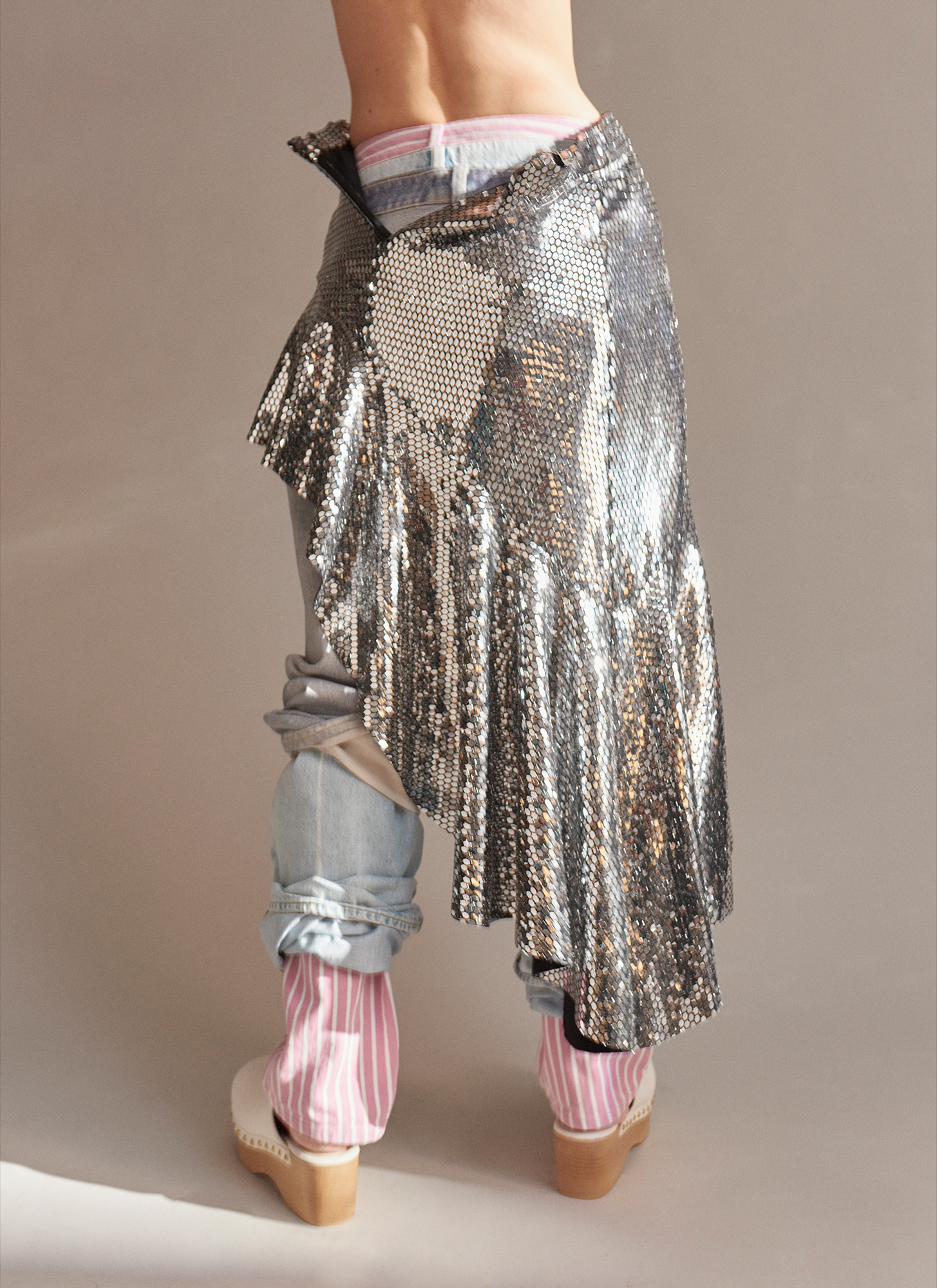 a person wearing a silver skirt