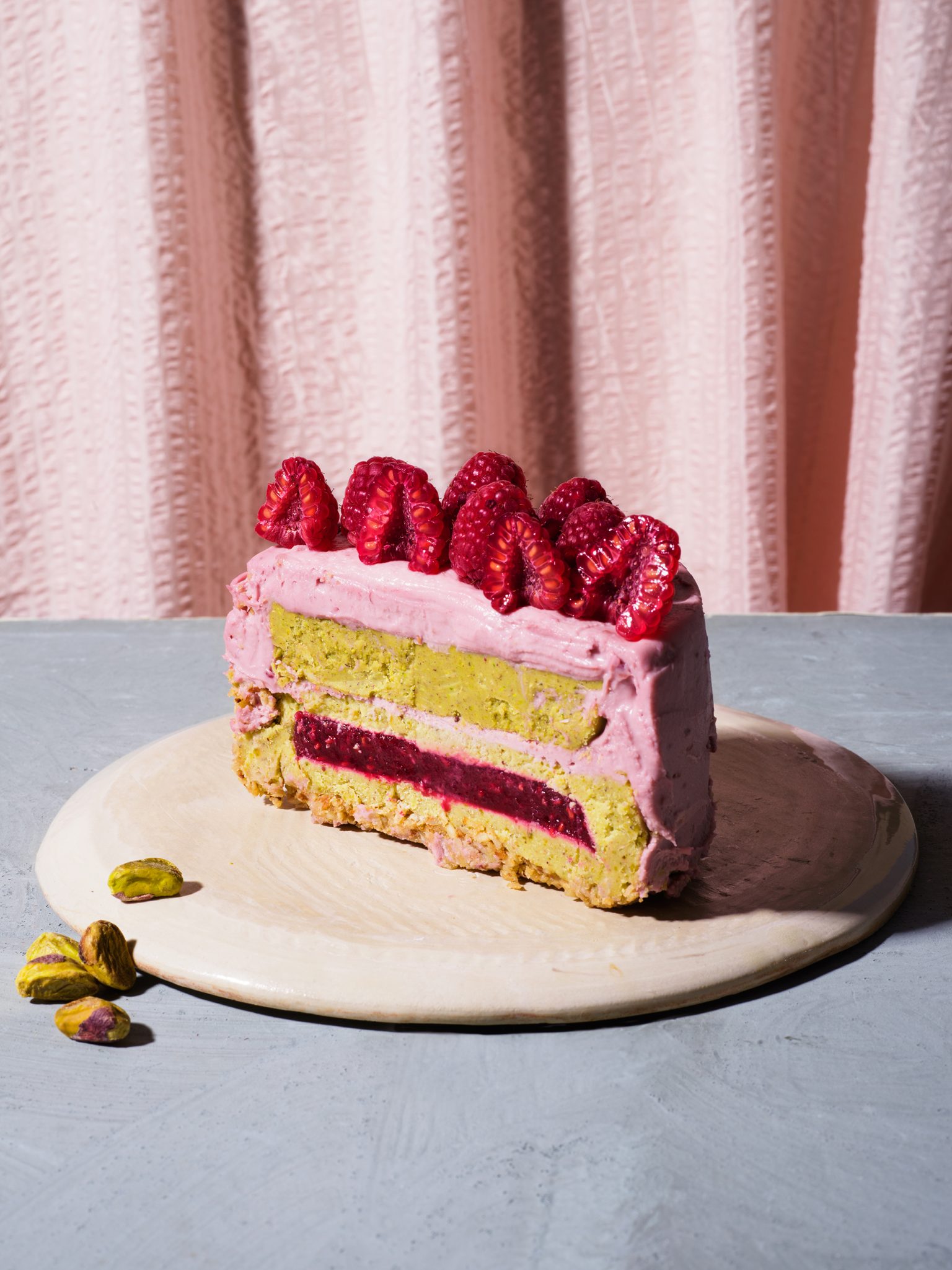a piece of cake with raspberries on top