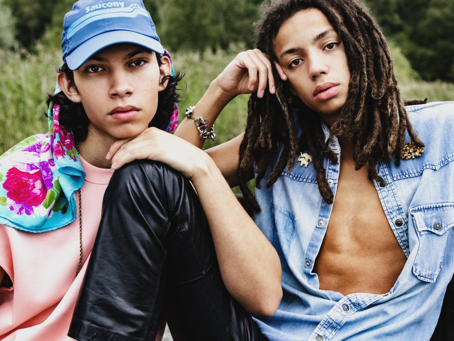 two men sitting on a rock