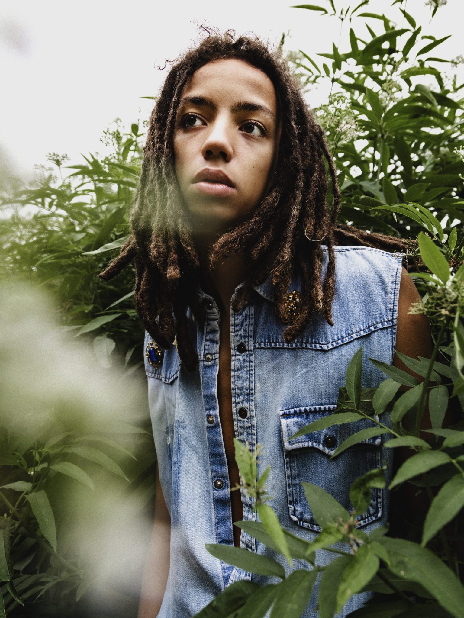 a man in a denim vest