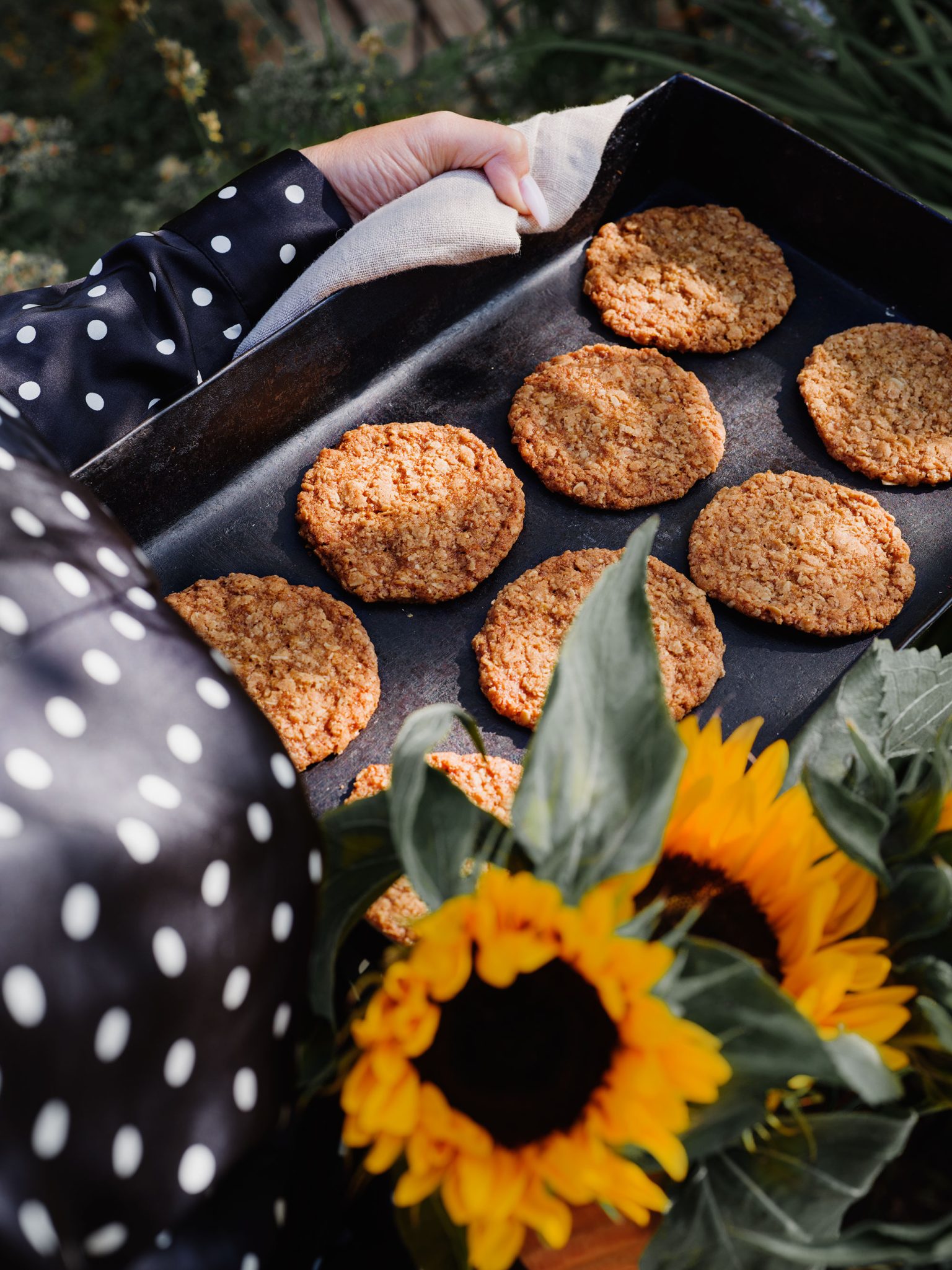 a person holding a tray of cookies
