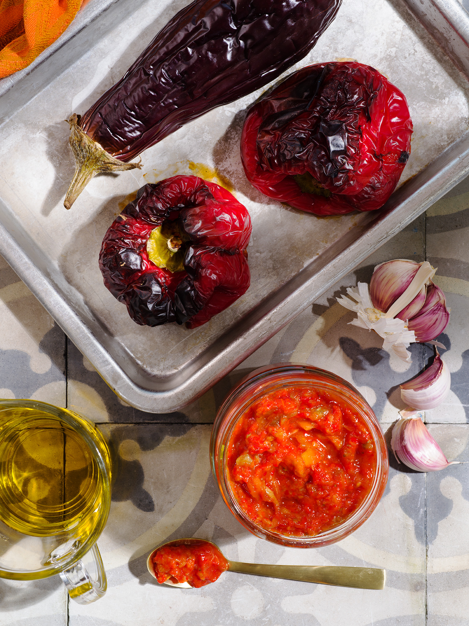 a tray of food with a couple of peppers and a jar of salsa