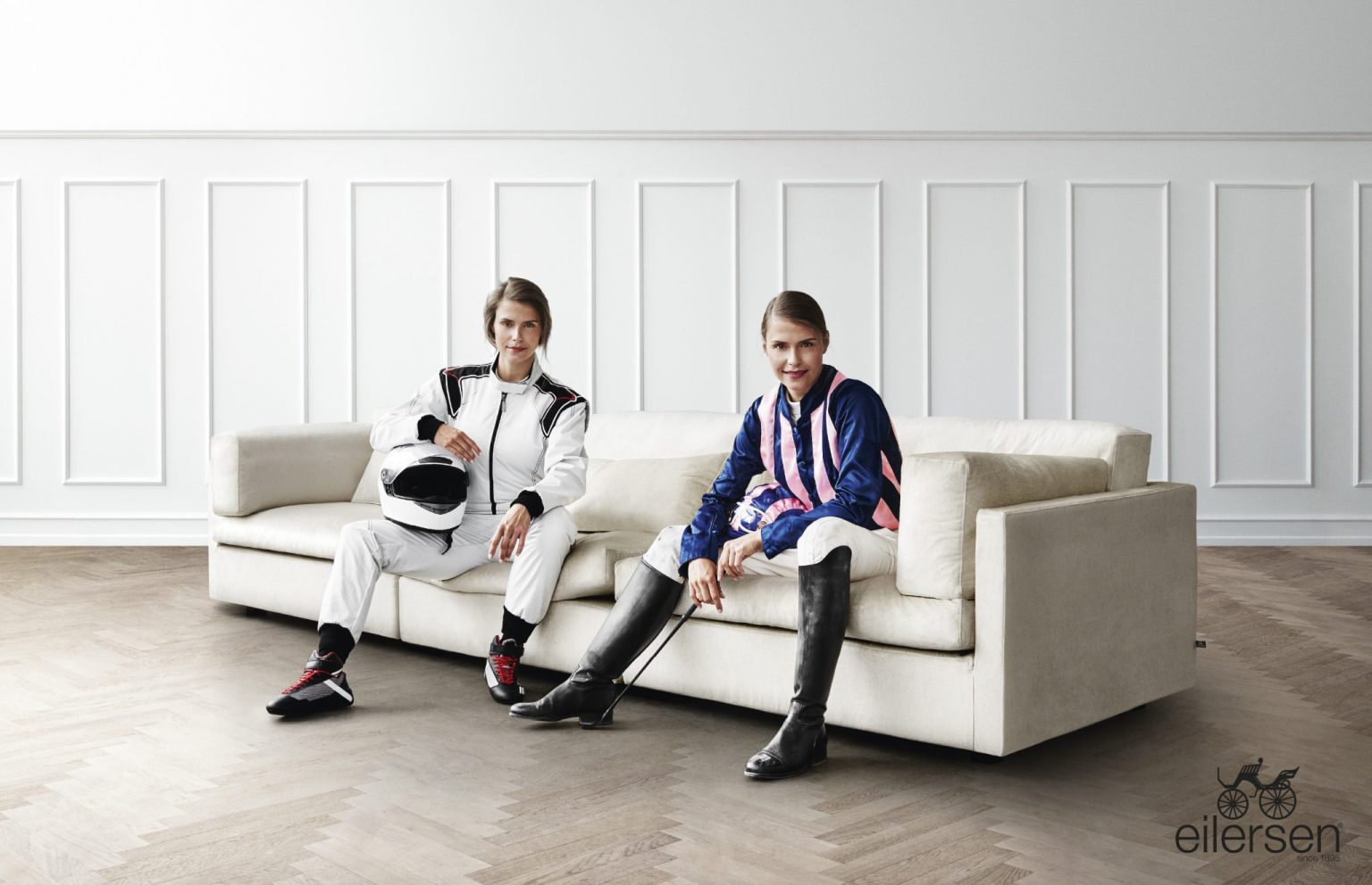 two women sitting on a couch