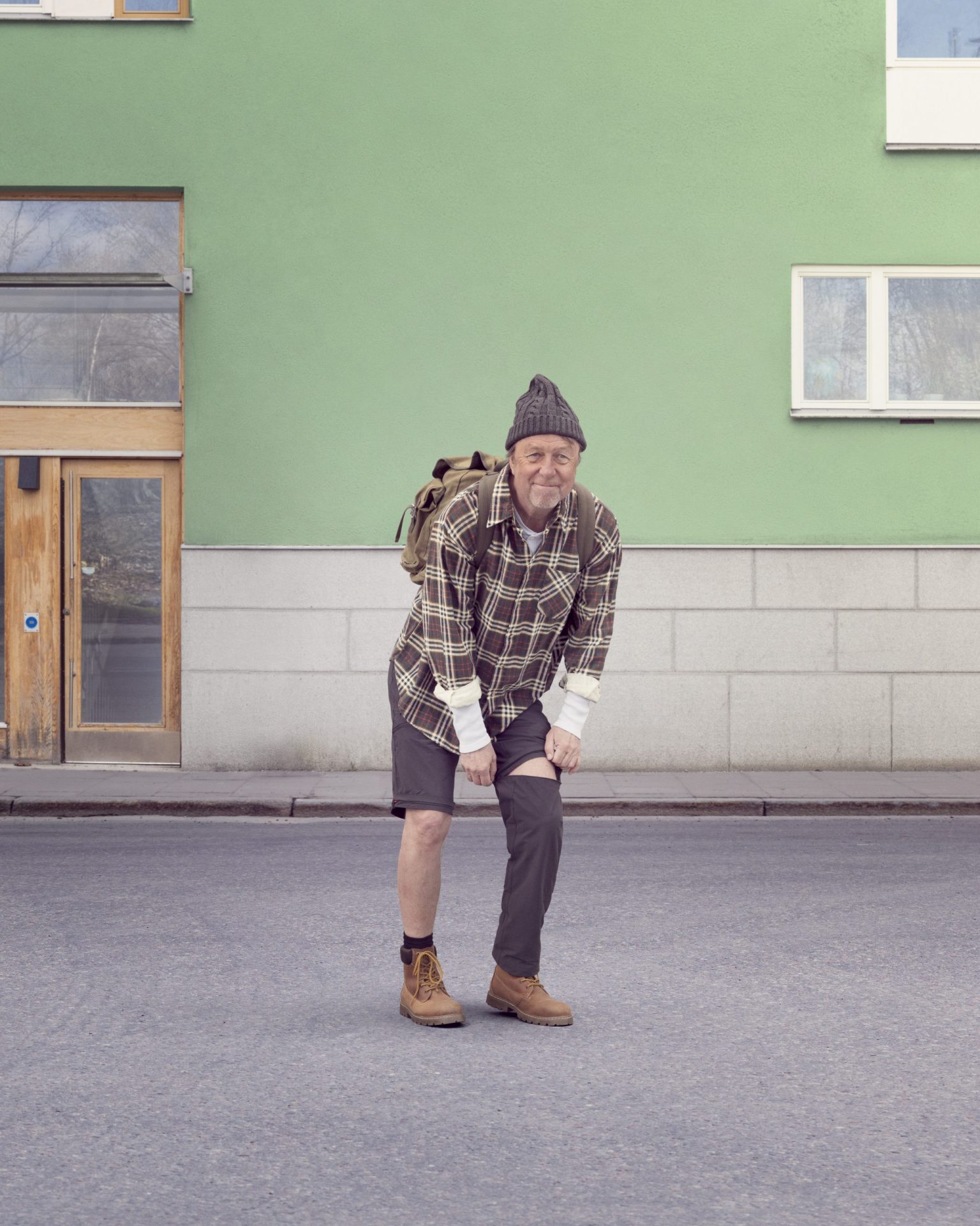 a man in a hat and plaid shirt