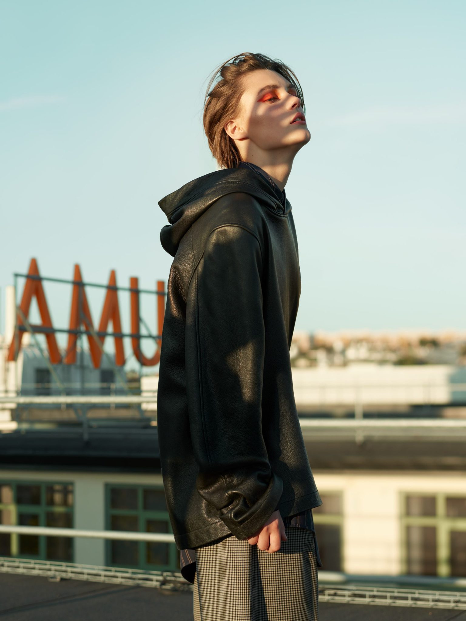 a person standing outside with their eyes closed