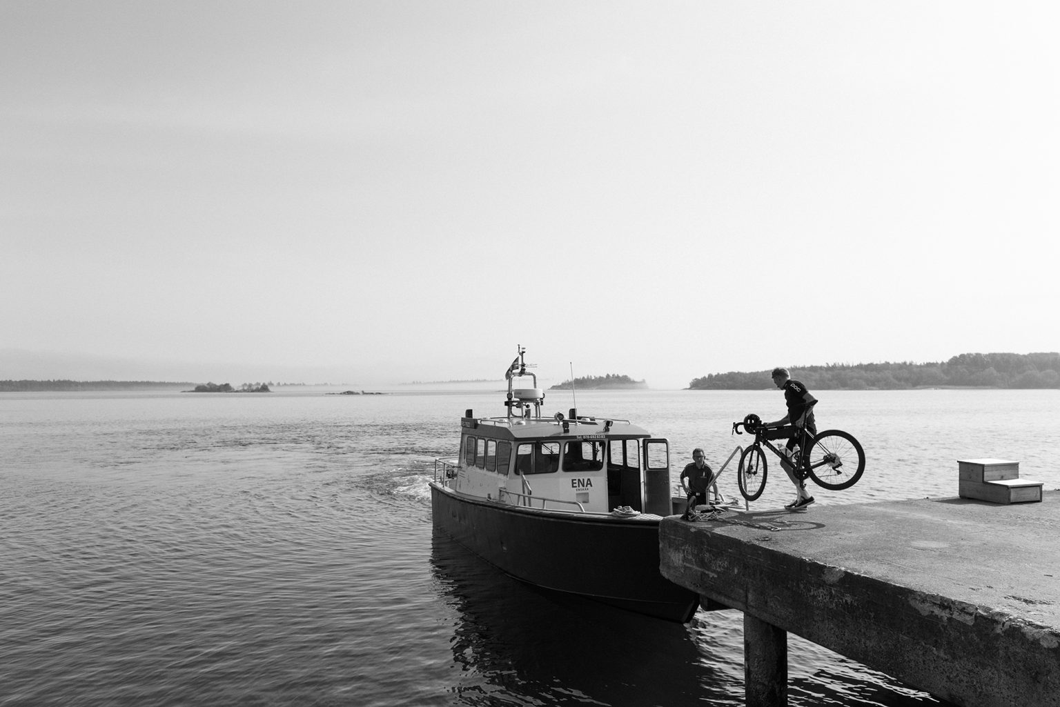 a boat and a man on a bicycle