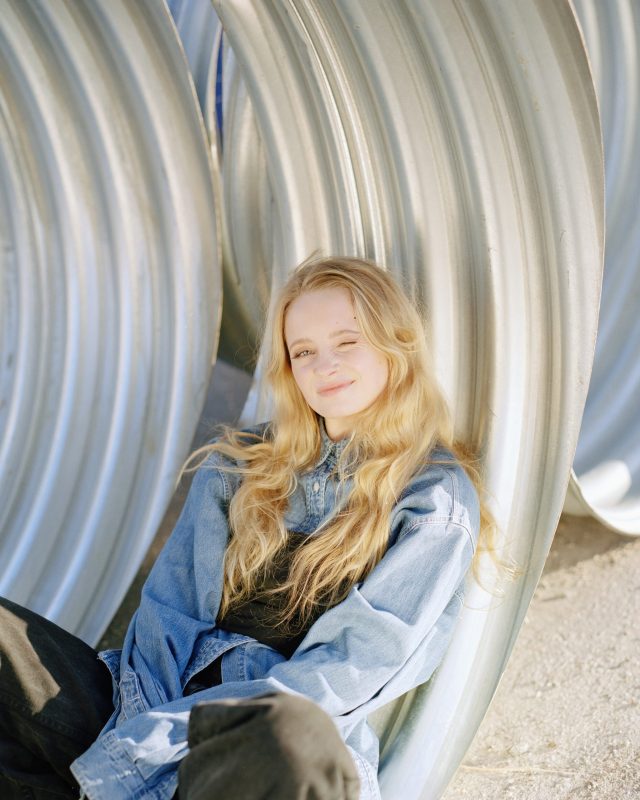 a woman sitting in a metal structure