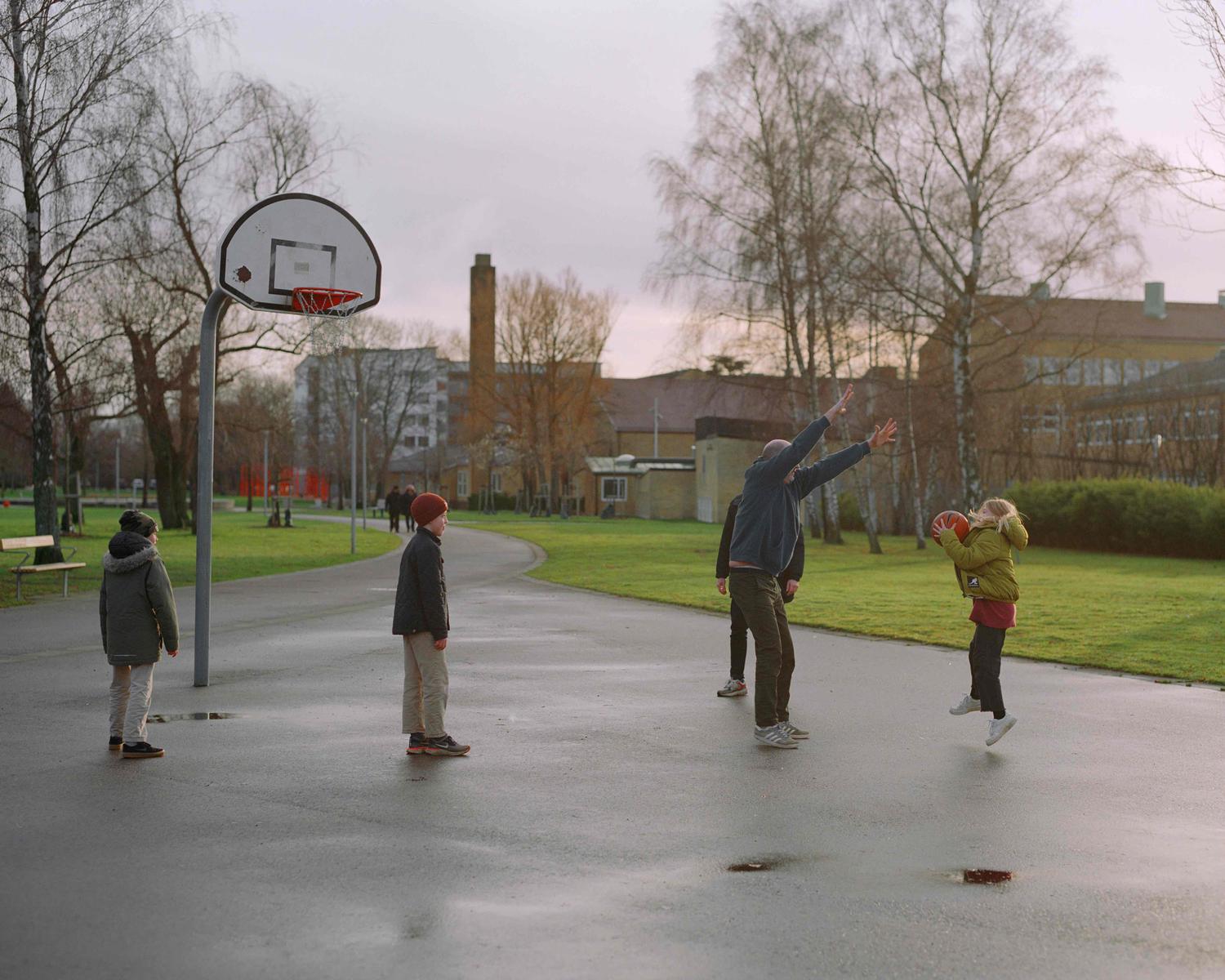 a group of people playing basketball