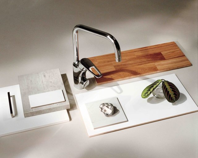 a faucet and a wood cutting board