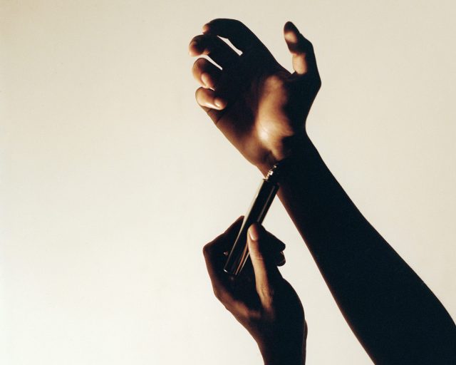 a person's hand holding a pen