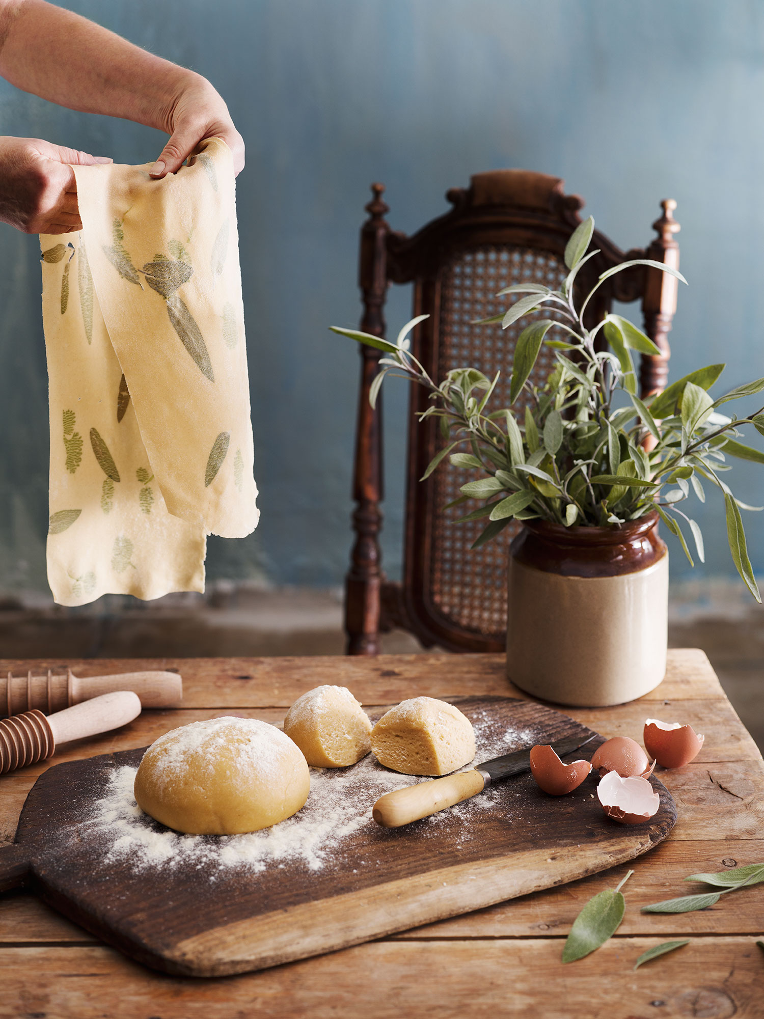 a hand holding a towel over dough