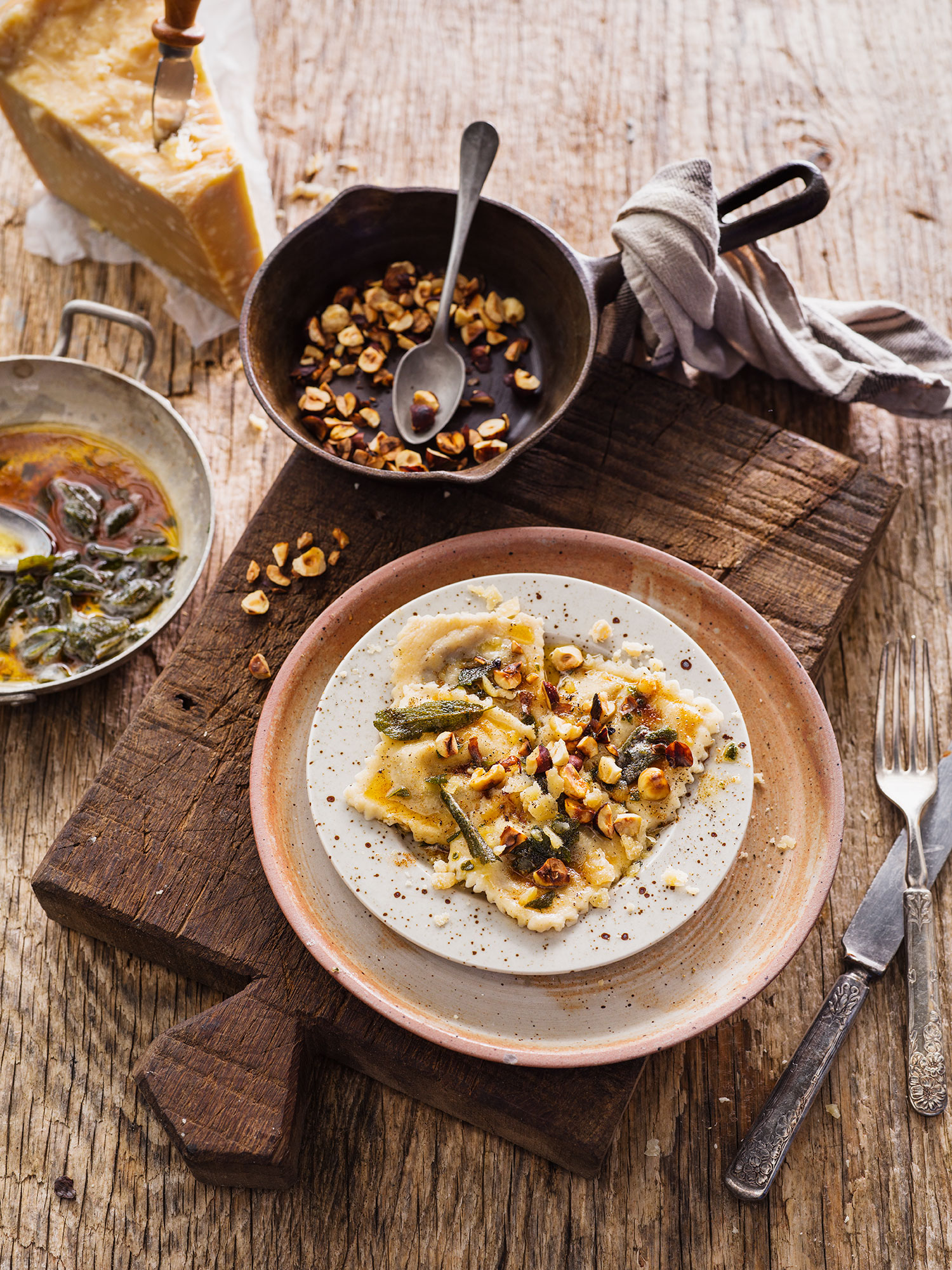 food on a plate with a pan of food and utensils
