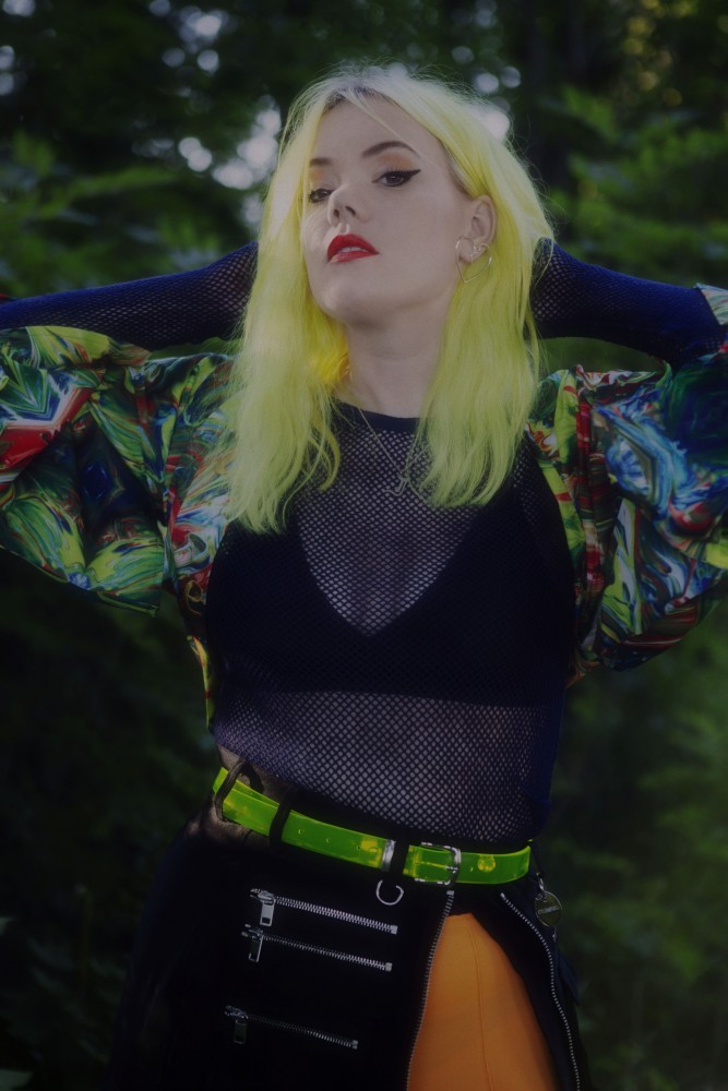 a woman with yellow hair and a colorful shirt